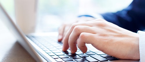 A person typing on a laptop